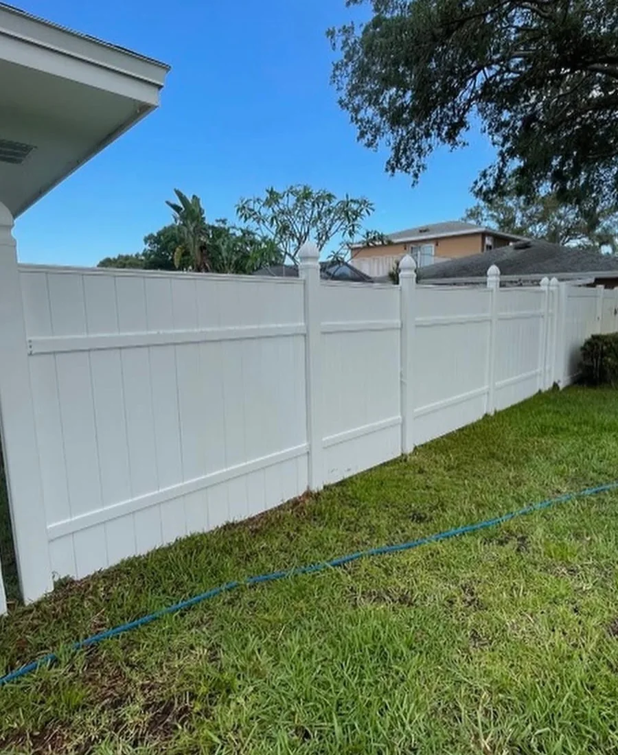 Bright white vinyl fence after professional cleaning