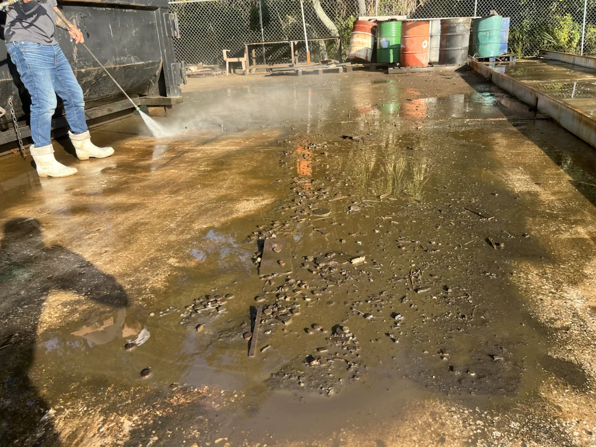Pressure washing in progress on an outdoor surface